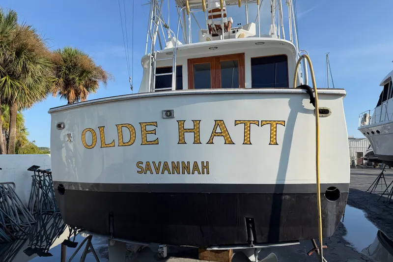 Slide: The Image of 1967 Hatteras 41 Convertible boat named "Olde Hatt" in Savannah, docked near palm trees. - 16