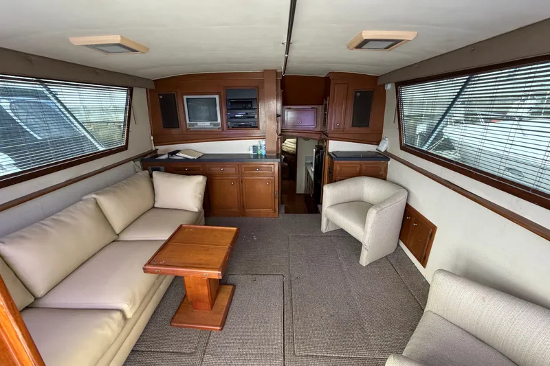 Slide: The Image of Interior of 1967 Hatteras 41 Convertible yacht with cozy seating and wooden cabinetry. - 2