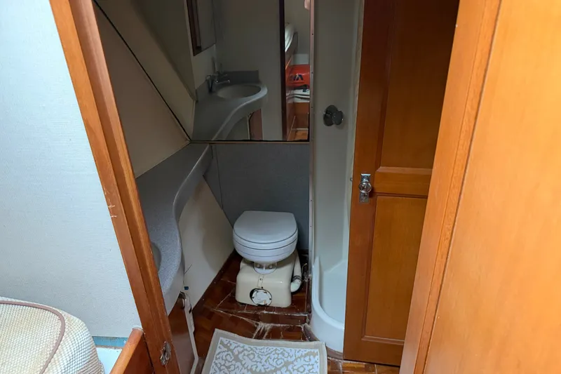 Slide: The Image of Bathroom interior of a 1967 Hatteras 41 Convertible yacht with toilet and sink. - 11