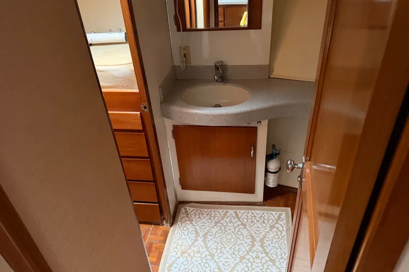 Slide: The Image of Bathroom interior of 1967 Hatteras 41 Convertible yacht with sink and wooden cabinetry. - 9
