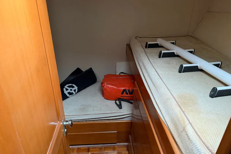 Slide: The Image of Interior cabin of 1967 Hatteras 41 Convertible with storage items on bed. - 10