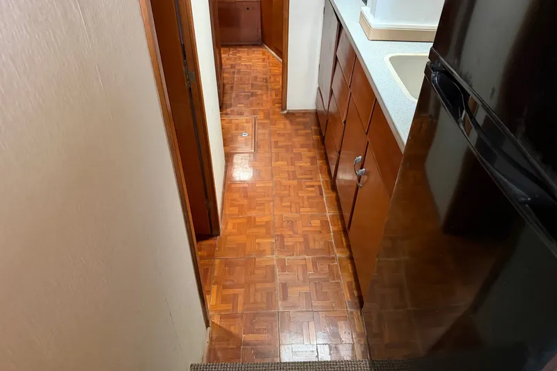 Slide: The Image of Interior view of 1967 Hatteras 41 Convertible yacht with wooden flooring and cabinetry. - 6