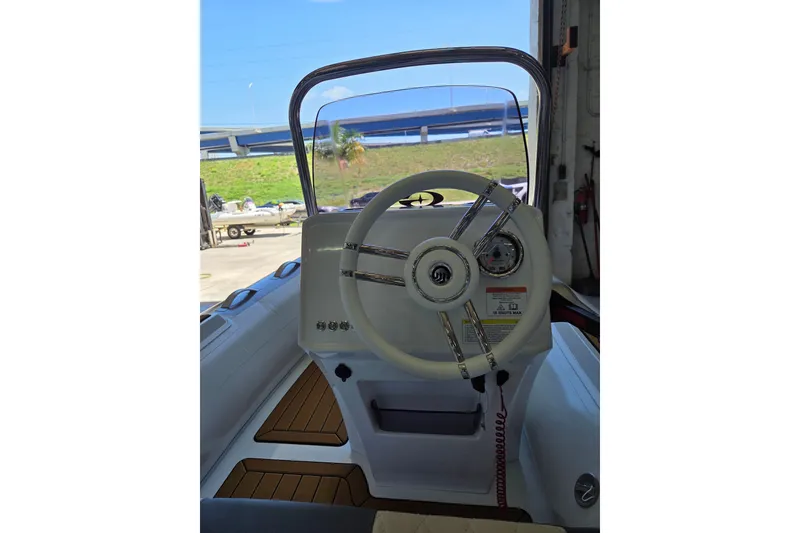 Slide: The Image of The image shows the helm of a Gala Viking V360 boat with a modern steering wheel and instruments. - 6
