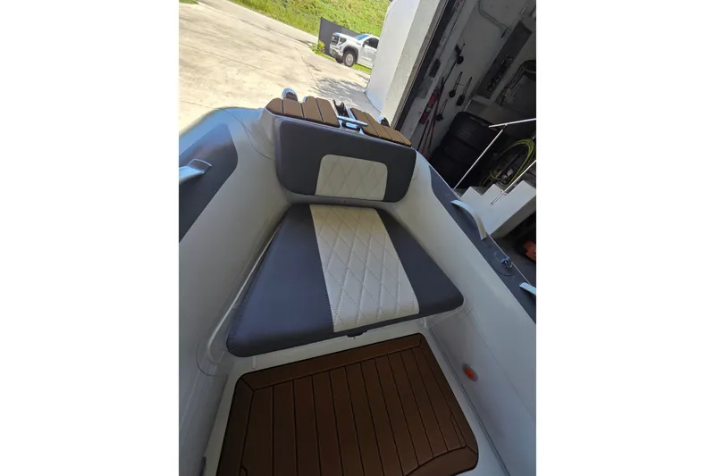 Slide: The Image of Interior view of a Gala Viking V360 boat with cushioned seating and wooden flooring. - 7