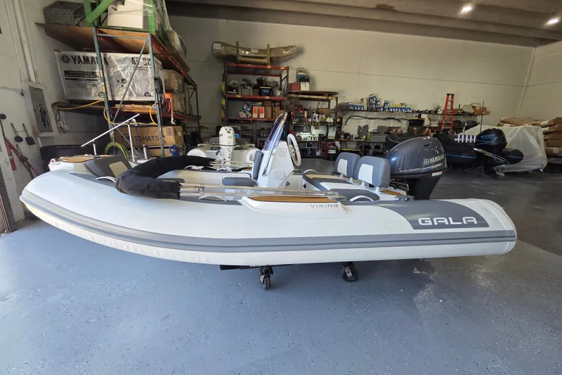 Slide: The Image of Gala Viking V360 2027 with Yamaha 40HP in a workshop. Inflatable boat with modern design. - 10