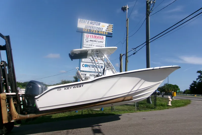 The Image of 2027 Key West 244 Center Console boat displayed at dealership, clear sky background. - 1