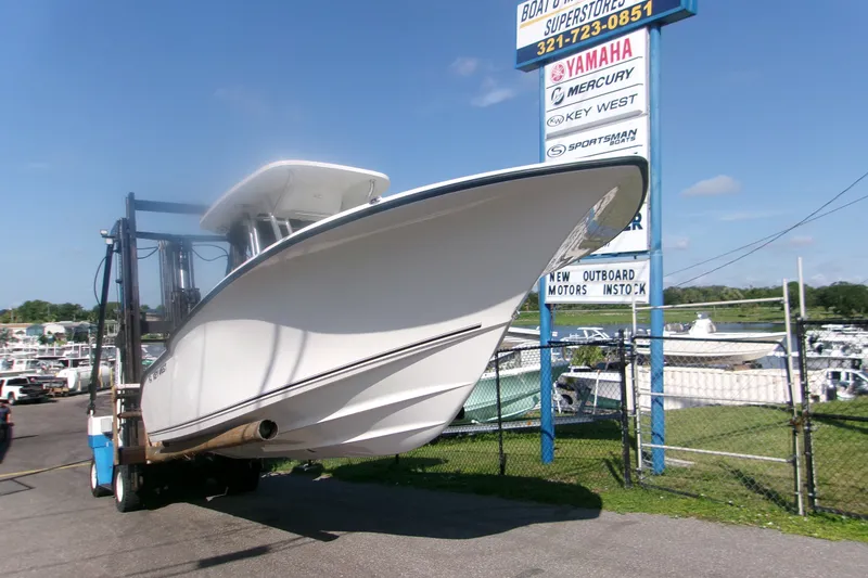 Slide: The Image of 2027 Key West 244 Center Console boat displayed at dealership with clear blue sky. - 2