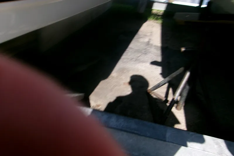 Slide: The Image of Shadow on pavement near a 2027 Key West 244 Center Console boat. - 5