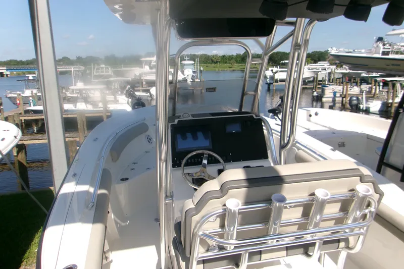 Slide: The Image of 2027 Key West 244 Center Console boat at marina, featuring modern helm and seating. - 6