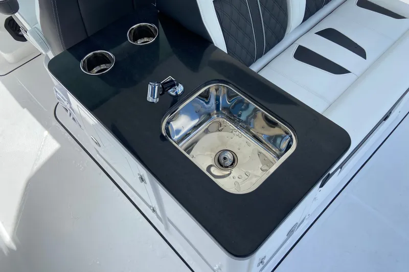 Slide: The Image of Luxury seating and sink area on 2027 Monterey Elite 30 OB boat. - 14