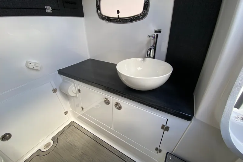 Slide: The Image of Luxurious bathroom interior of 2027 Monterey Elite 30 OB boat with modern sink and cabinetry. - 26