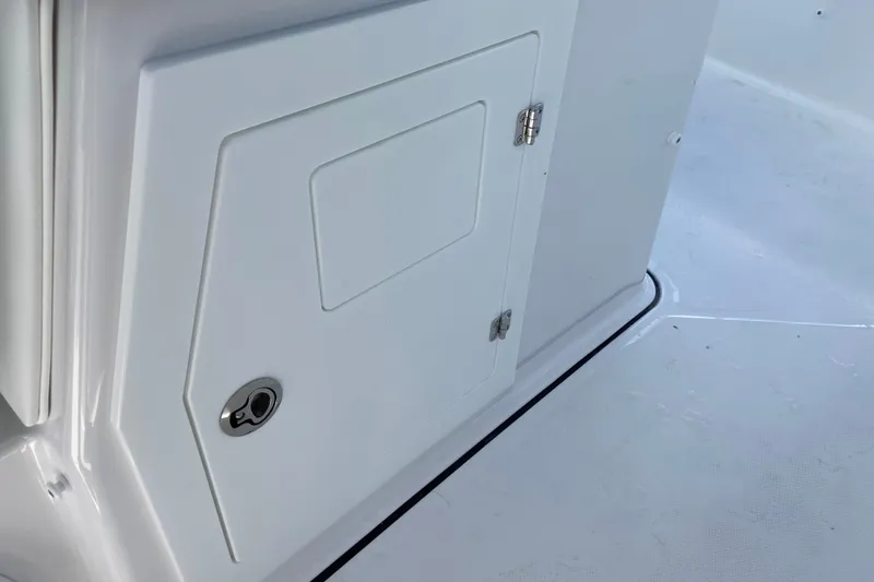 Slide: The Image of 2027 Monterey Elite 30 OB boat storage compartment with sleek white finish. - 15