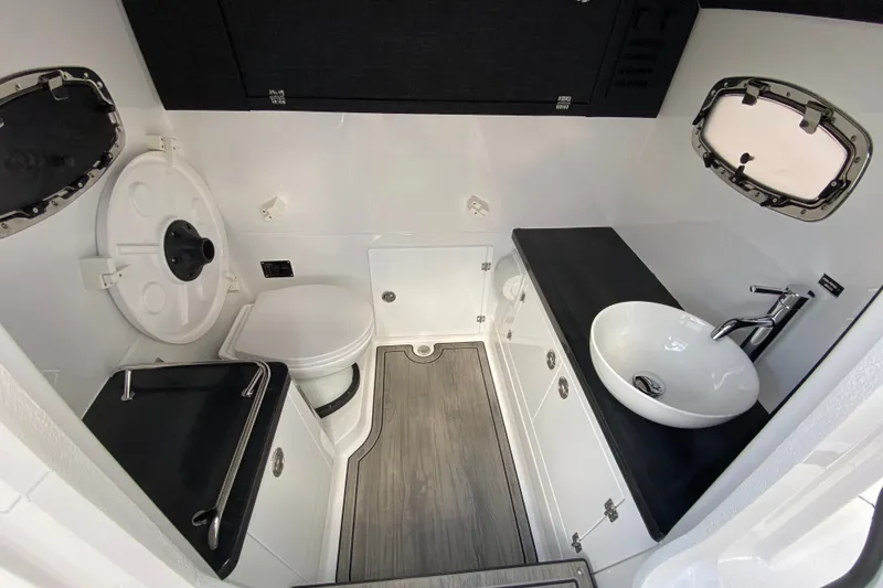 Slide: The Image of Modern bathroom interior of 2027 Monterey Elite 30 OB boat, featuring sleek fixtures and wood flooring. - 25
