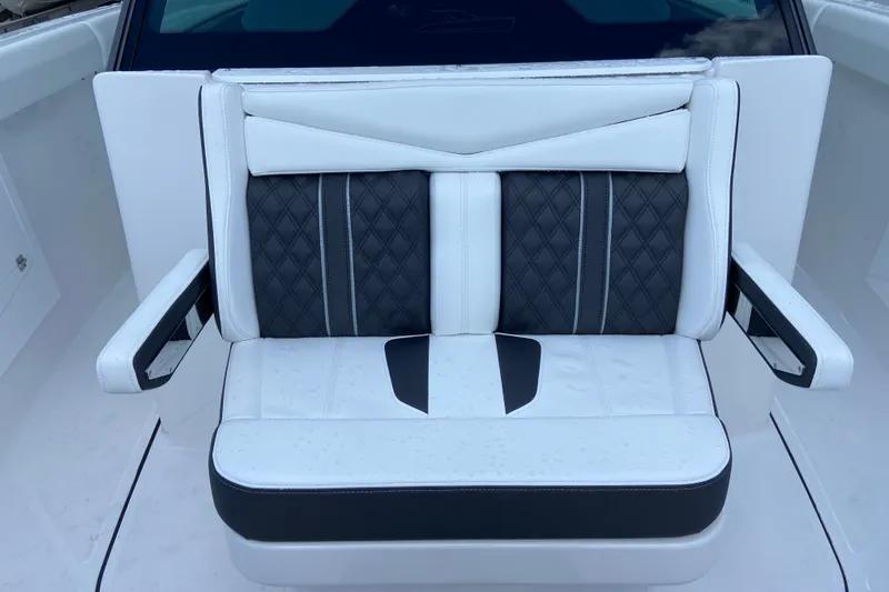 Slide: The Image of Luxury seating on 2027 Monterey Elite 30 OB boat, featuring white and black upholstery. - 24