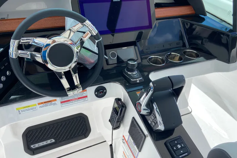 Slide: The Image of Cockpit of 2027 Monterey Elite 30 OB boat with modern steering and controls. - 19