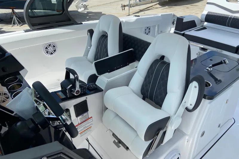 Slide: The Image of Luxurious interior of 2027 Monterey Elite 30 OB boat with plush seating and modern controls. - 18