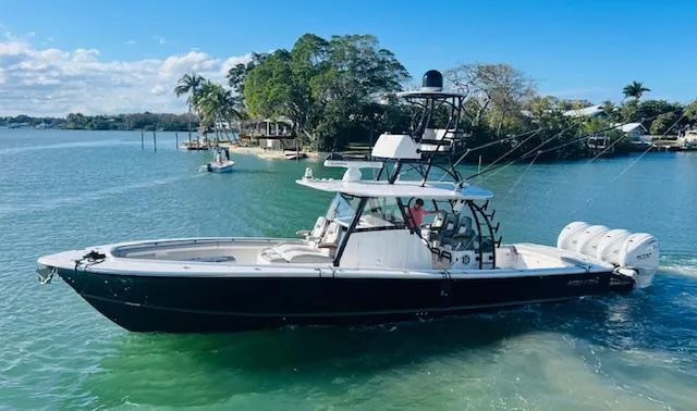 Slide: The Image of 2024 Regulator 41 boat on clear water with lush greenery in the background. - 9