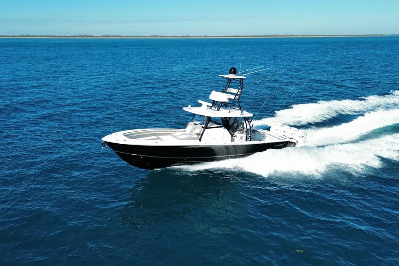 Slide: The Image of 2024 Regulator 41 boat cruising on open blue ocean waters. - 0