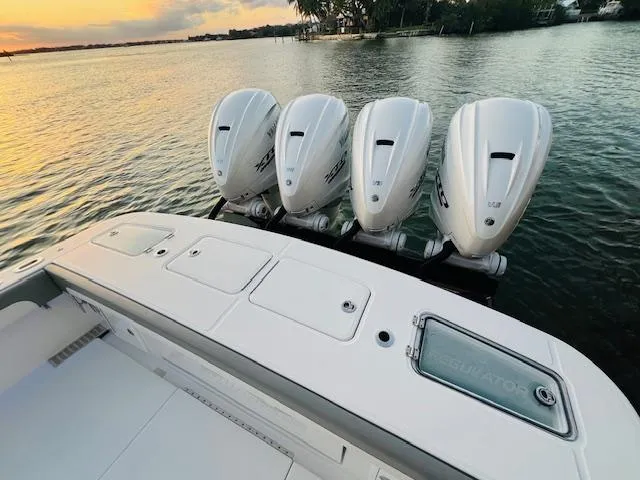 Slide: The Image of 2024 Regulator 41 boat with four powerful outboard engines on a serene water backdrop. - 33