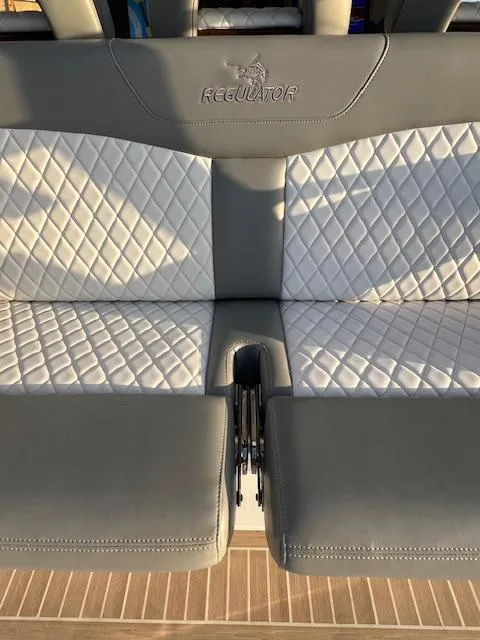 Slide: The Image of 2024 Regulator 41 boat seat with diamond-stitched upholstery and integrated cup holder. - 17