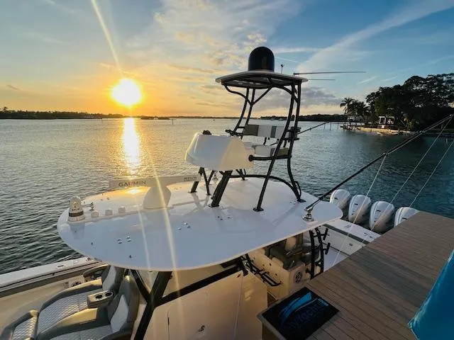 Slide: The Image of 2024 Regulator 41 boat at sunset on calm waters, featuring advanced navigation equipment. - 15