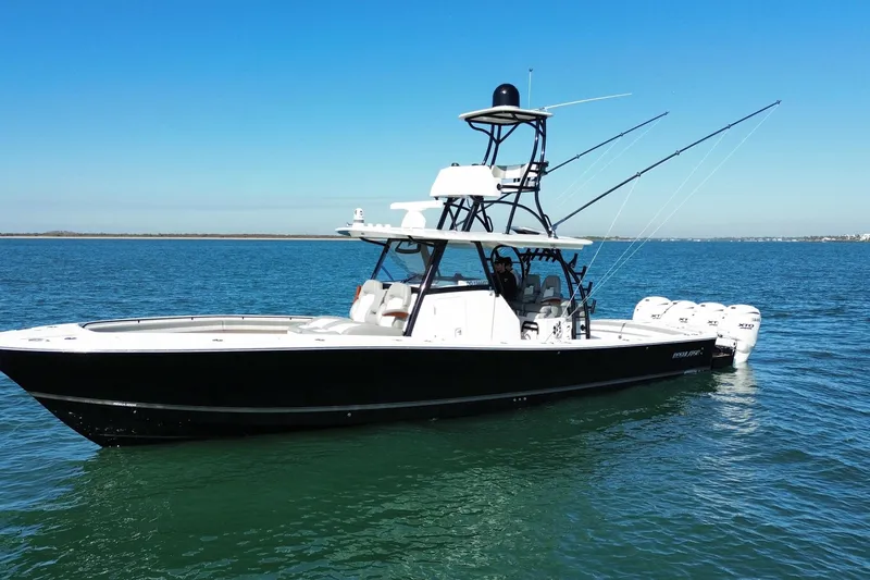 Slide: The Image of 2024 Regulator 41 boat on calm blue water, featuring sleek design and multiple outboard engines. - 5