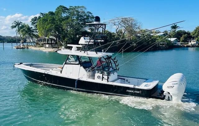 Slide: The Image of 2024 Regulator 41 boat cruising in a scenic tropical waterway. - 10