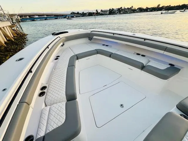 Slide: The Image of 2024 Regulator 41 boat with spacious seating, docked by the water at sunset. - 26