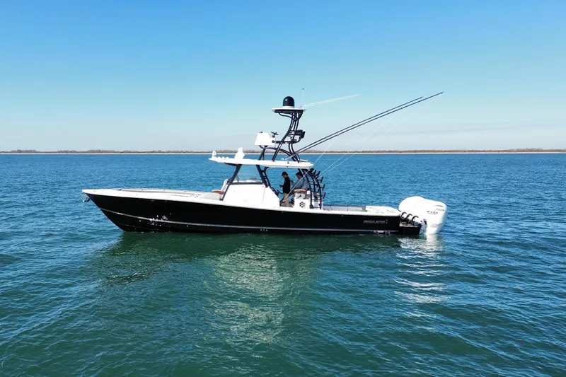 Slide: The Image of 2024 Regulator 41 boat on calm blue water under clear sky. - 3