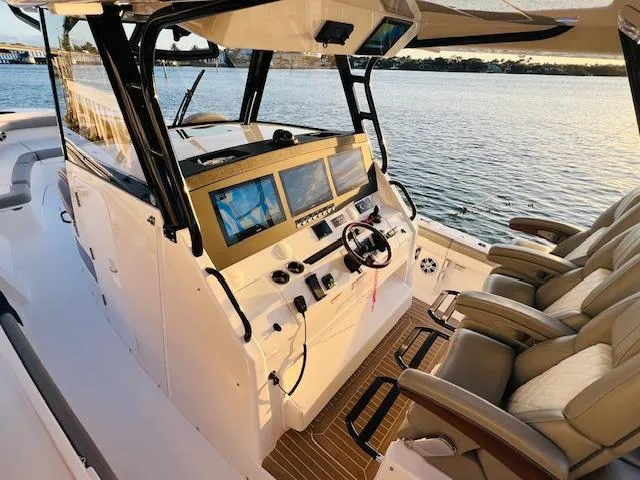 Slide: The Image of 2024 Regulator 41 boat cockpit with advanced navigation screens and luxurious seating. - 14