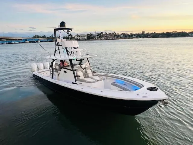 Slide: The Image of 2024 Regulator 41 boat on calm water at sunset. - 36