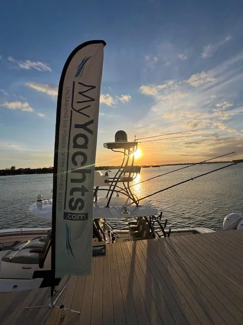 Slide: The Image of 2024 Regulator 41 yacht at sunset, docked with MyYachts.com banner. - 18
