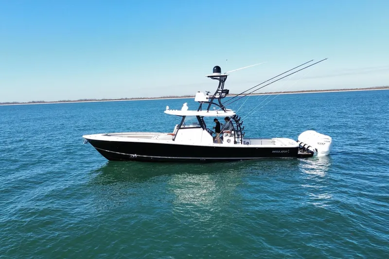 Slide: The Image of 2024 Regulator 41 boat on open water, featuring sleek design and powerful engines. - 2