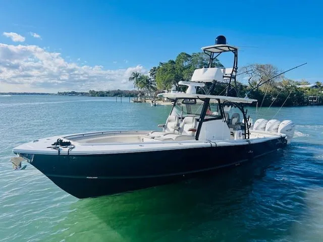 Slide: The Image of 2024 Regulator 41 boat on clear water, featuring sleek design and multiple outboard engines. - 11