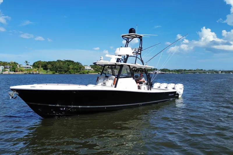 The Image of 2024 Regulator 41 boat on calm water under clear blue sky. - 0