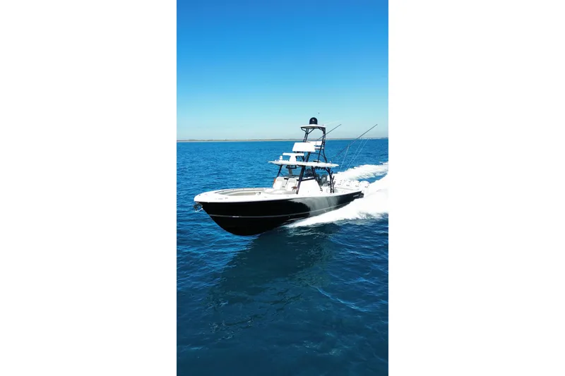 Slide: The Image of 2024 Regulator 41 boat cruising on open blue ocean waters. - 7