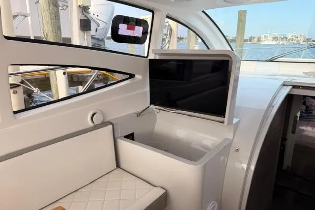 Slide: The Image of Interior of 2025 Real 40 HT Luxury yacht with modern seating and TV. - 21