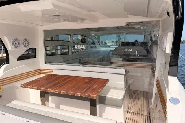 Slide: The Image of Luxurious interior of 2025 Real 40 HT yacht with elegant seating and wooden table. - 14