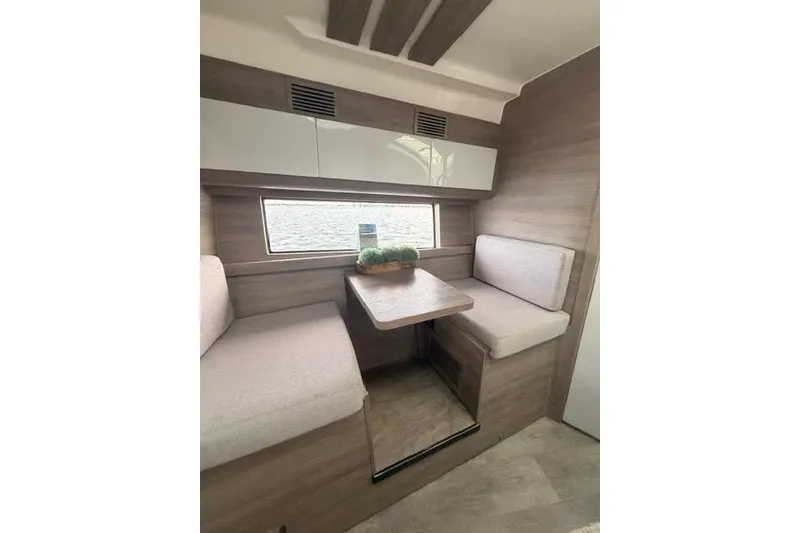 Slide: The Image of 2025 Real 40 HT Luxury interior with modern seating and table setup. - 38