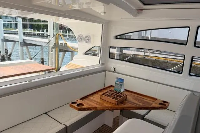 Slide: The Image of Interior of 2025 Real 40 HT Luxury yacht with elegant seating and wooden table. - 18