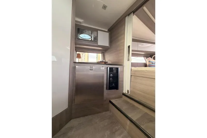 Slide: The Image of Interior of 2025 Real 40 HT Luxury yacht, featuring modern kitchenette and cozy cabin space. - 42