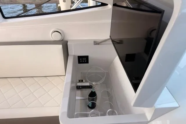 Slide: The Image of Luxurious interior of 2025 Real 40 HT yacht with TV, seating, and champagne setup. - 22