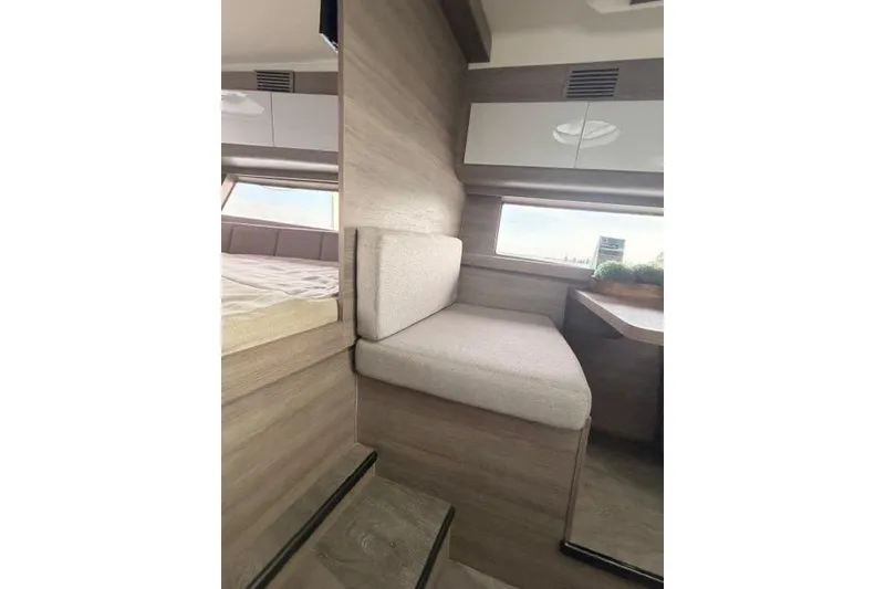 Slide: The Image of Interior of 2025 Real 40 HT Luxury yacht with modern seating and wooden finishes. - 39