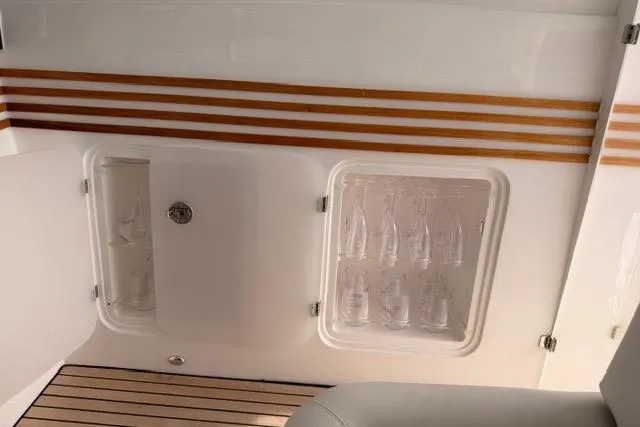 Slide: The Image of Interior of 2025 Real 40 HT Luxury yacht with built-in storage and elegant wood accents. - 27
