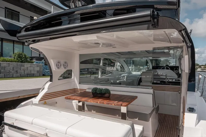 Slide: The Image of Luxurious 2025 Real 40 HT yacht interior with elegant seating and wooden table. - 13