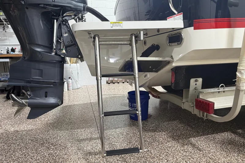 Slide: The Image of 2015 Regulator 23 boat with ladder and outboard motor in garage. - 29