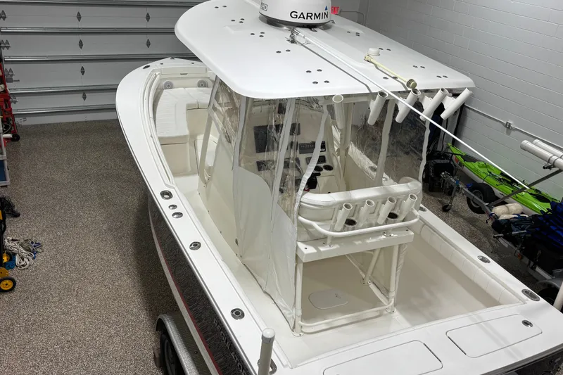 Slide: The Image of 2015 Regulator 23 boat in garage with Garmin equipment, featuring a clean white interior. - 26