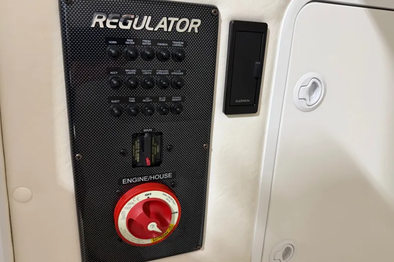 Slide: The Image of Control panel of a 2015 Regulator 23 boat with switches and Garmin device. - 35