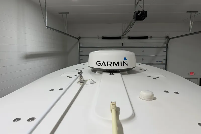 Slide: The Image of 2015 Regulator 23 boat with Garmin radar in a garage setting. - 32