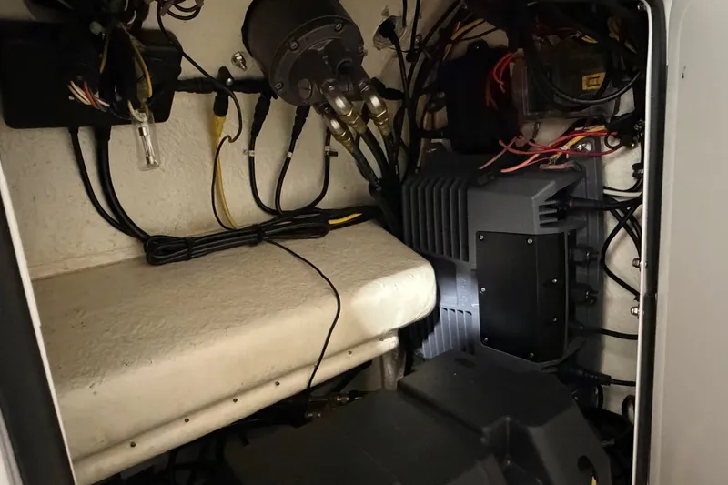 Slide: The Image of Electrical components inside a 2015 Regulator 23 boat, showcasing wiring and equipment. - 42